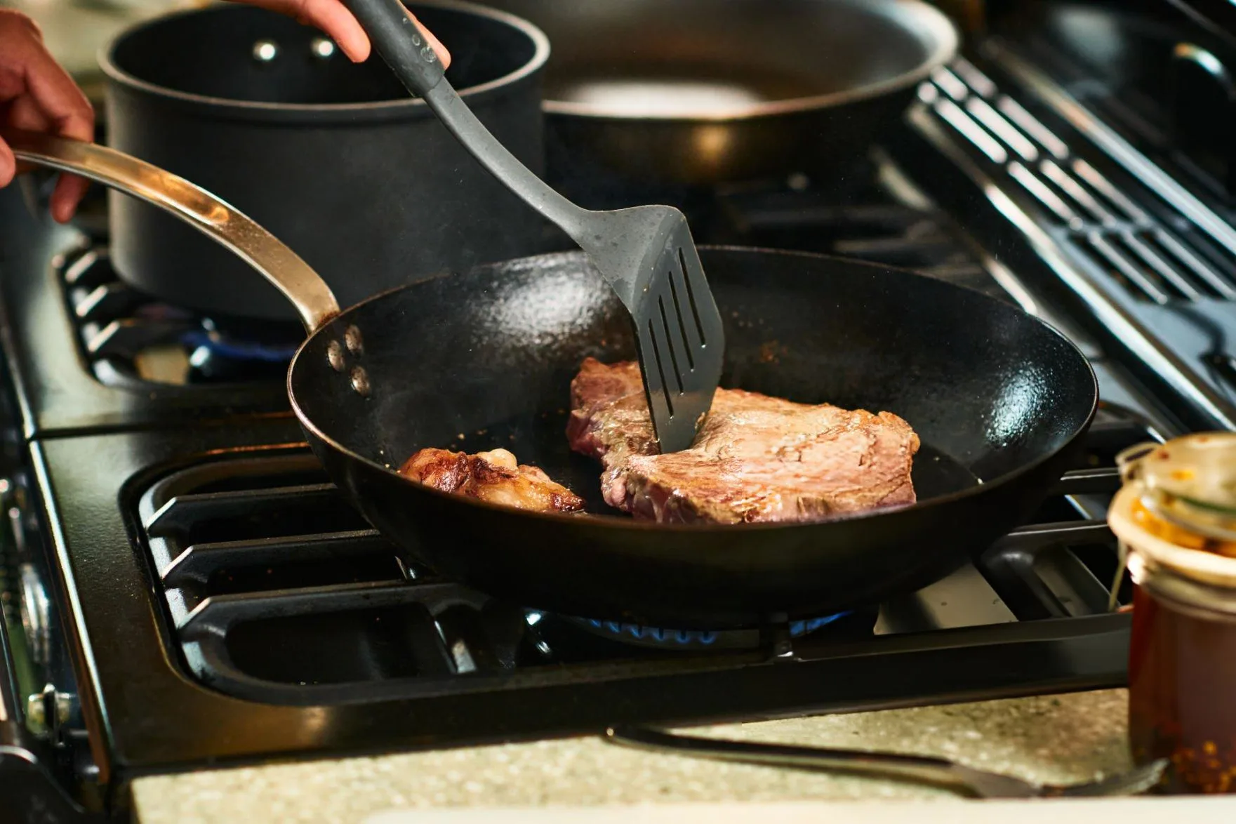 The Top 5 Unhealthiest Foods That Diabetics Should Avoid Person using spatula to cook steak in frying pan